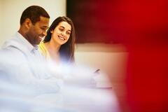 Woman sitting at a desk working on marketing platform.